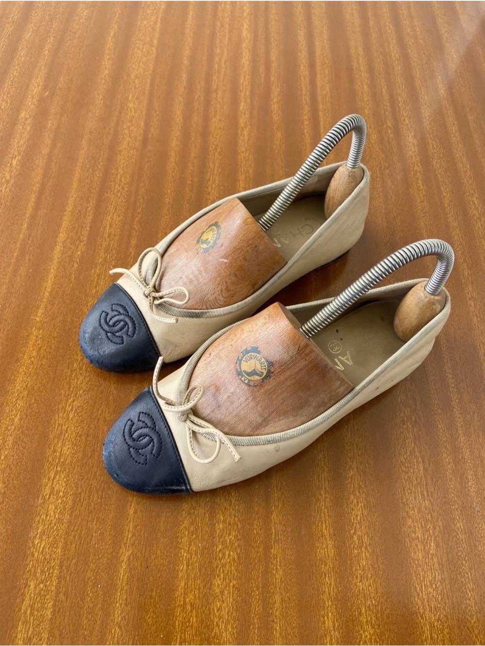 CHANEL Beige and Black Cap-Toe Ballet Flats with Bow